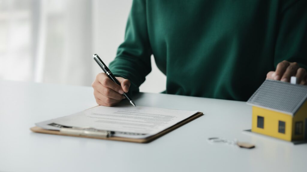 The salesperson of the housing estate in the project is preparing and verifying the contract of sale